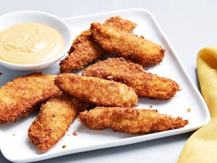 Crispy baked healthy chicken fingers served with a red pepper dipping sauce