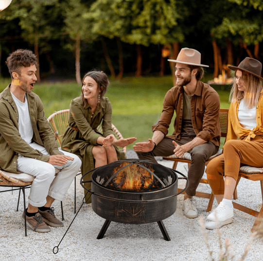 A decorative black metal fire pit with a mesh screen cover