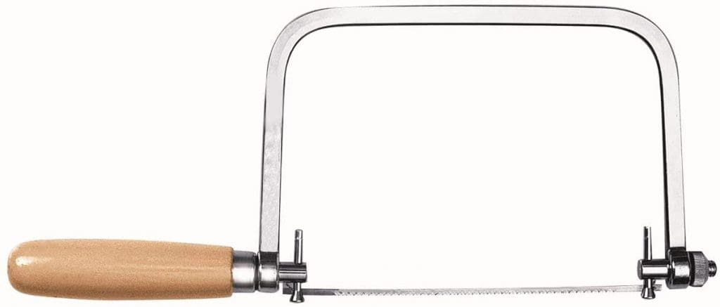 Professional coping saw with a U-shaped steel frame on a wooden workbench