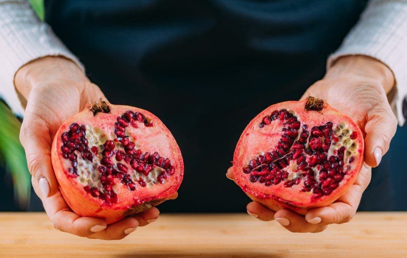 Fresh Pomegranate Fruit A freshly halved pomegranate revealing bright red, juicy seeds.