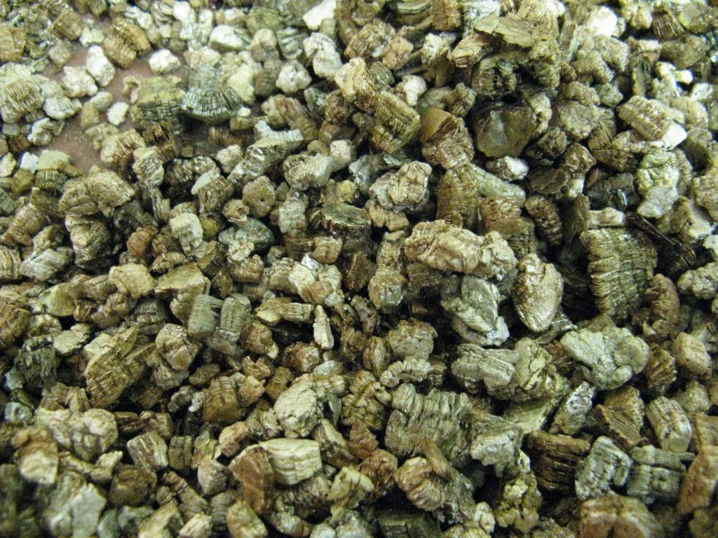 Vermiculite Flakes A close-up of golden brown, flaky vermiculite used for soil amending.