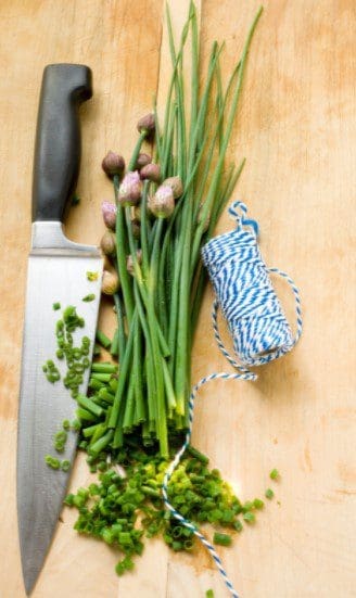 Finely Chopped Chives A pile of finely chopped, bright green fresh chives ready for cooking.