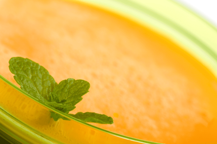 Chilled Casaba Soup A bowl of chilled yellow Casaba melon soup garnished with a lime wheel.