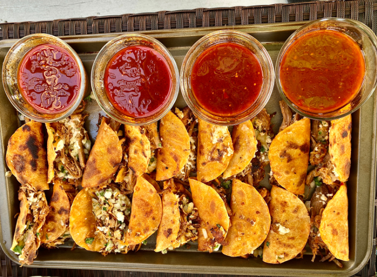 Birria Tacos Plate A plate of freshly griddled Birria tacos topped with cilantro.