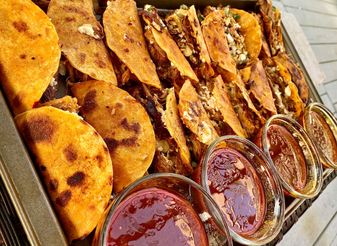 Authentic Birria Tacos A plate of delicious birria tacos with a bowl of rich consomme dipping broth.