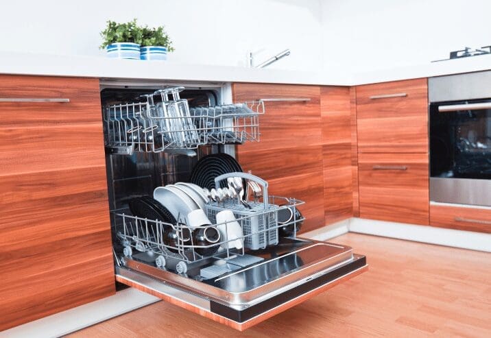 Stainless steel Frigidaire dishwasher installed under a kitchen countertop in a modern U.S. kitchen