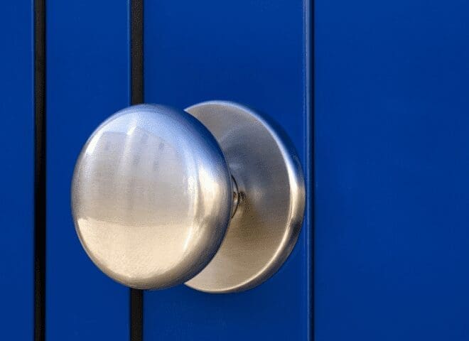 Removing the Old Doorknob Using a screwdriver to carefully remove the mounting screws from an old doorknob.