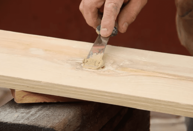 Wood Putty vs Wood Filler A side-by-side comparison of wood putty vs wood filler being applied to a wooden board.