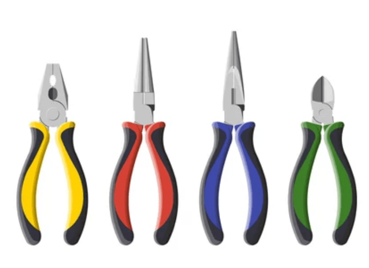 Types of Pliers A collection of various types of pliers laid out on a wooden workbench.