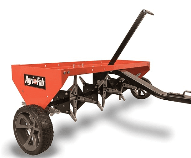 Agri-Fab 48-Inch Tow-Behind Plug Aerator, showing its wider 48-inch transport deck and loaded tines during spring aeration.