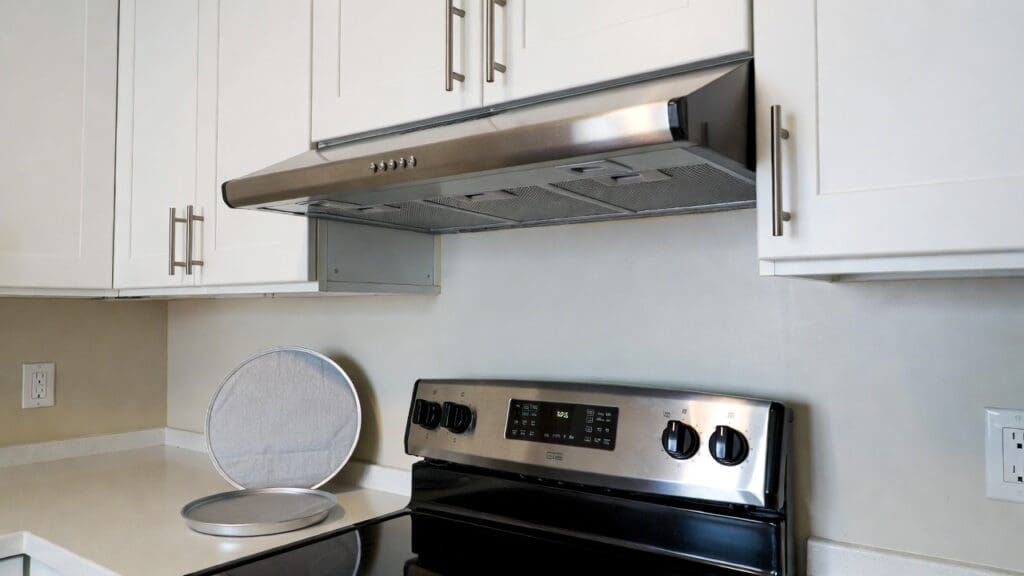 Ductless undercabinet range hood installed above a stove in a small apartment kitchen Gardenfrontier Ductless under cabinet range hood installed above a stove in a small apartment kitchen