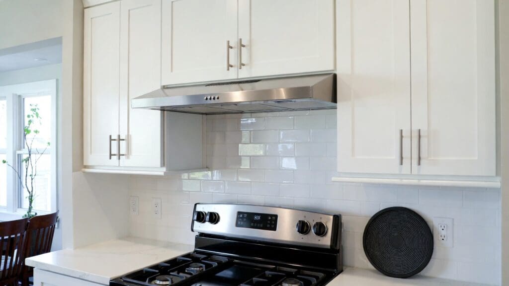 Under cabinet ductless range hood installed above a stove in a modern apartment kitchen Gardenfrontier Under cabinet ductless range hood installed above a stove in a modern apartment kitchen